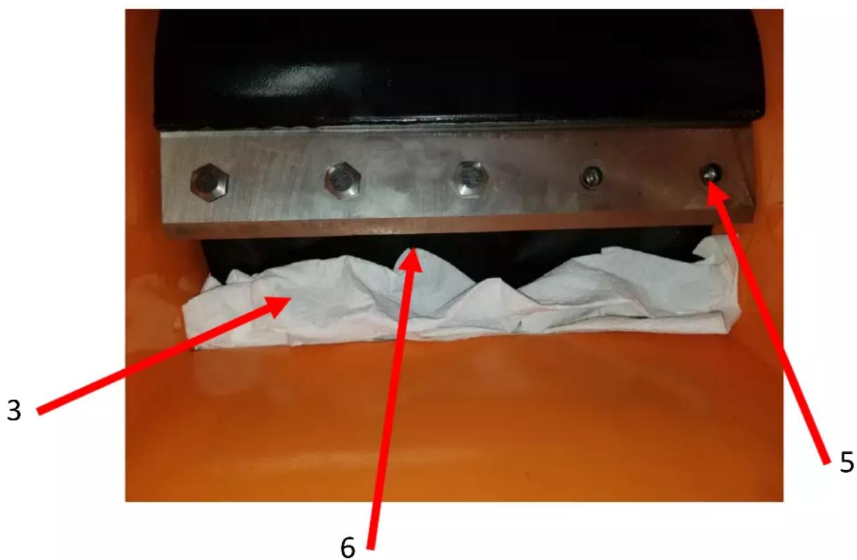 Technical diagram showing a mechanical component with numbered annotations pointing to features like bolts, bolts, and paper-like material.