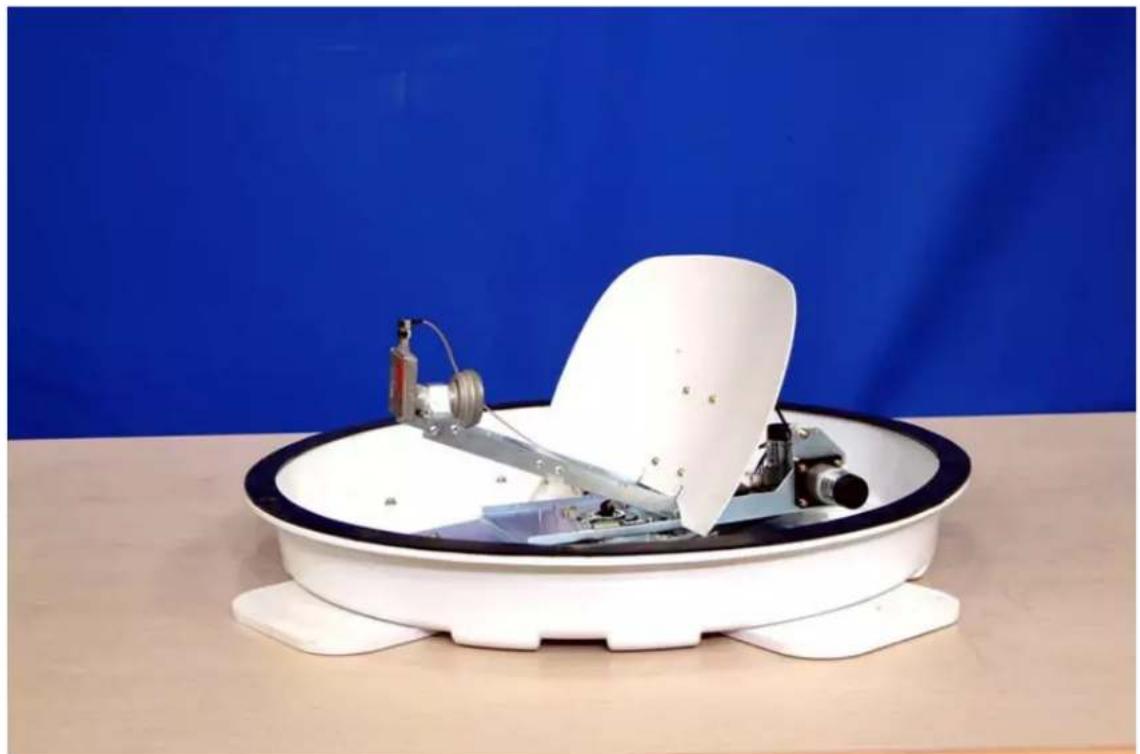 White satellite dish mounted on a circular base with mechanical components, set against a blue backdrop (no text or symbols visible)