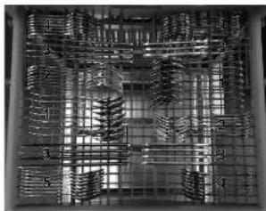 Close-up of a grid-patterned surface with repeating curved shapes and numbered labels (no readable text or symbols)