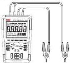 Diagram of a digital multimeter connected to two test probes, showing measurement ranges and connections.