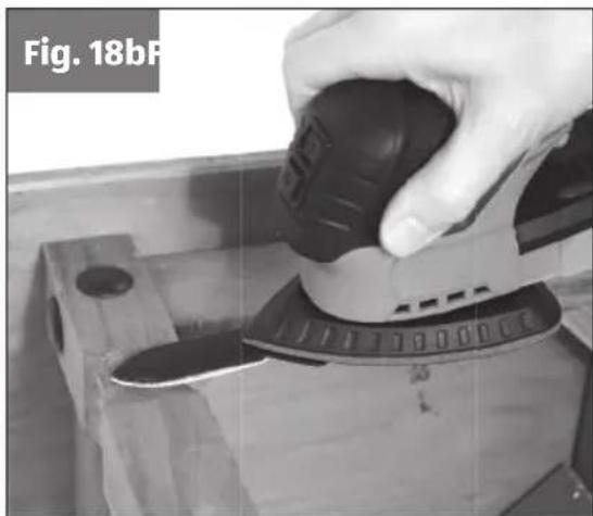 Close-up of a hand operating a mechanical device with a black knob, labeled 'Fig. 18bF' in the corner (no other text or symbols visible)