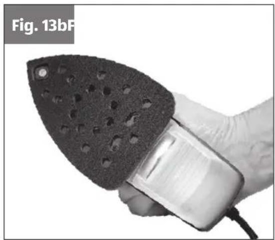 Hand holding a sandal tool with perforated surface and attached device (no text or symbols visible)