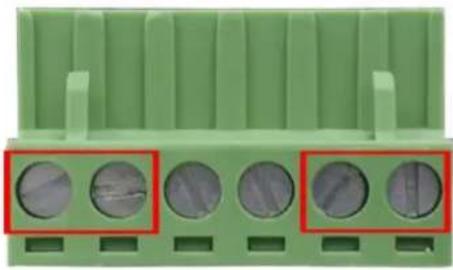 Close-up of a green plastic component with five circular holes, highlighted by red boxes (no text or symbols visible)