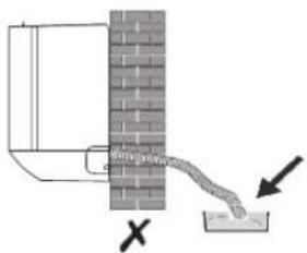 Diagram showing a pipe or pipe passing through a brick wall with an arrow indicating direction, marked with an 'X' symbol.
