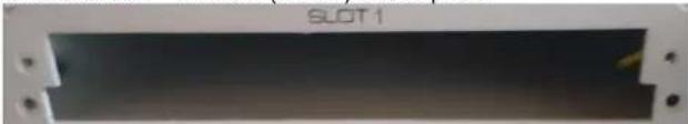 Close-up of a black rectangular electronic component labeled 'SLOT1' with mounting holes (no readable text beyond label)
