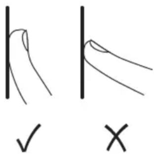 Hand-drawn diagram showing two hand positions with check and cross marks, likely illustrating correct and incorrect ways to write or mark.