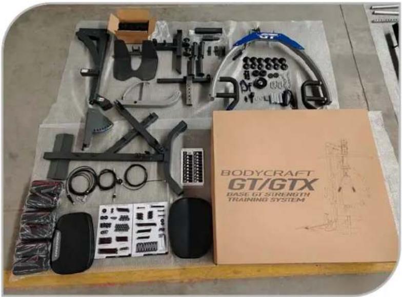 Workbench with various mechanical components including a body-craft, sensors, and training system (no visible text or symbols on main objects)