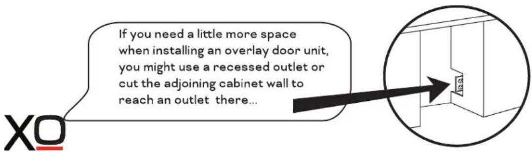 If you need a little more space when installing an overlay door unit, you might use a recessed outlet or cut the adjoining cabinet wall to reach an outlet there...