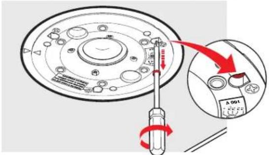 Diagram showing a screwdriver inserted into a circular mechanical component with a red arrow indicating rotation, and an inset close-up of the component labeled 'A 001'.