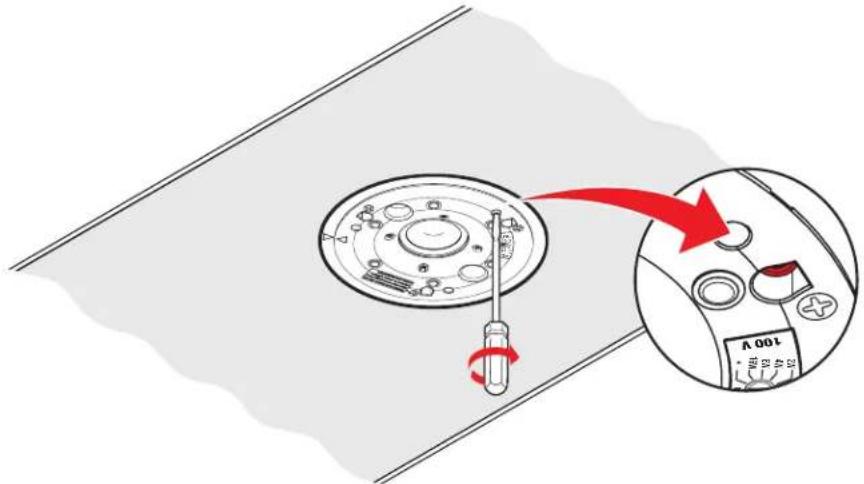 Diagram showing a screwdriver inserted into a circular component with a 100V indicator, illustrating the process of turning a motor.