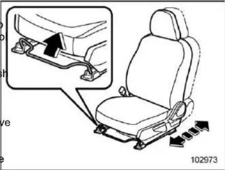 Diagram showing car seatbelt buckle assembly with magnified detail view and directional arrows indicating movement