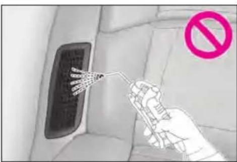 Diagram showing a hand holding a device with a no-smoking symbol, next to a car interior panel with visible wiring and a warning sign.