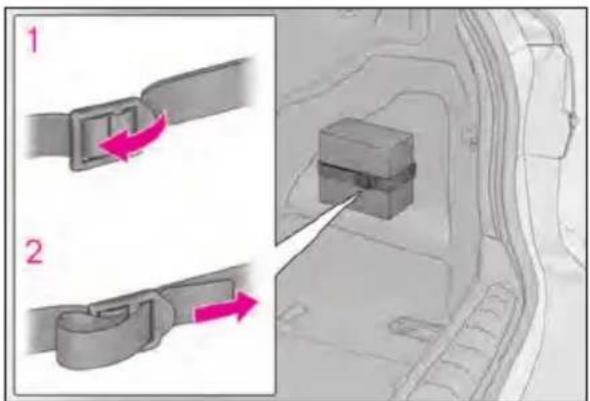 Diagram showing two car seatbelt buckle clips labeled 1 and 2, with arrows indicating movement or assembly.