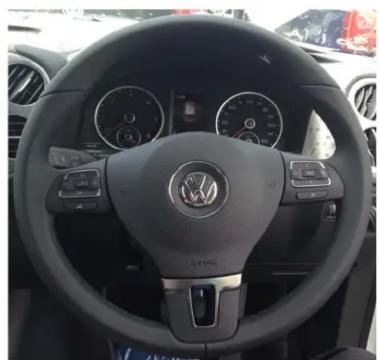 Interior view of a car dashboard with Volkswagen logo and speedometer (no visible text or symbols)