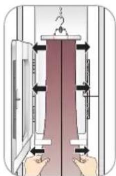 Diagram showing hand positioning of a vertical panel with arrows indicating movement, likely for electrical or mechanical assembly.