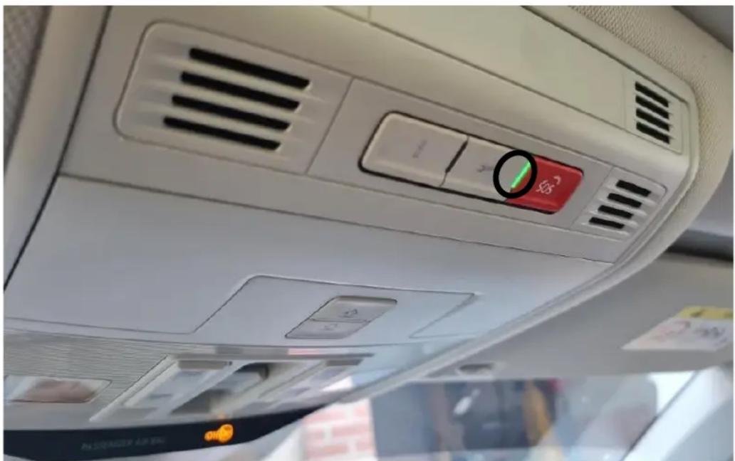 Interior view of a car air conditioner unit with control panel and indicator lights (no readable text or symbols)