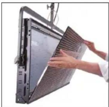 Person installing a large panel with mesh filter (no visible text or symbols)