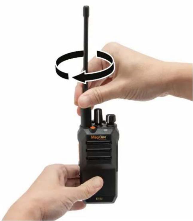 Close-up of hands holding a Mag One walkie-talkie with a circular arrow indicating rotation (no text or symbols on device)