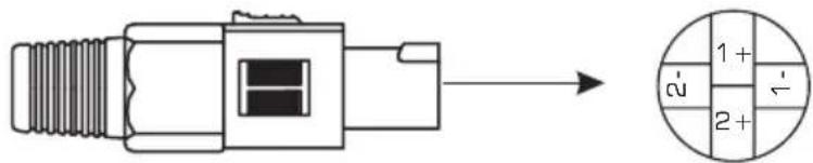 Diagram showing a mechanical connector with an arrow pointing to a circular component labeled with polarity indicators.
