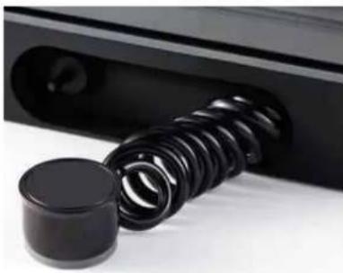 Close-up of a black plastic roller being inserted into a black plastic housing (no text or symbols visible)