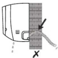 Diagram showing a pipe or pipe passing through a brick wall with an arrow and cross symbol indicating flow direction.