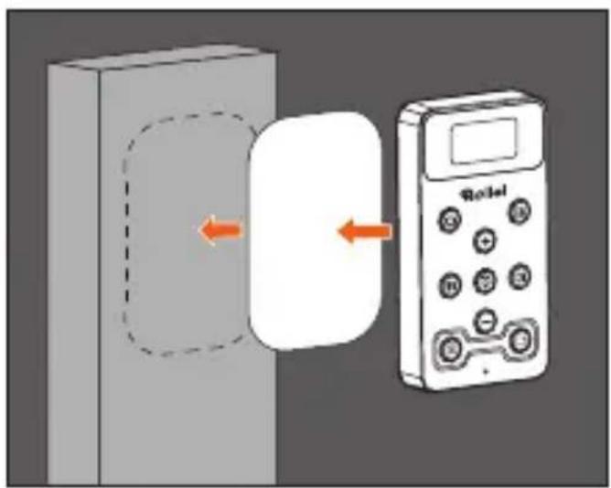 Diagram showing a device connected to a wall-mounted device with directional arrows indicating movement or interaction.