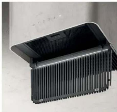 Close-up of a black heat sink with ribbed cooling fins, placed on a plain surface (no text or symbols visible)