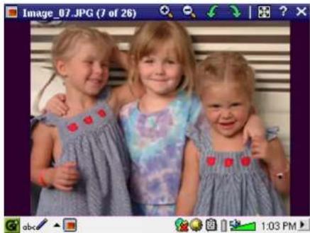 Three young girls in blue patterned dresses posing together (no text or symbols visible)