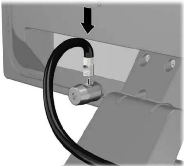 Close-up of a mechanical component with a black cable inserted, showing a downward arrow (no text or symbols visible)