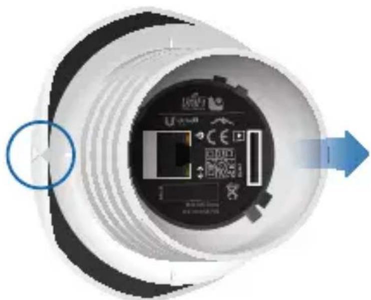 Top-down view of a circular device with internal components and a blue arrow indicating direction (no text or symbols)