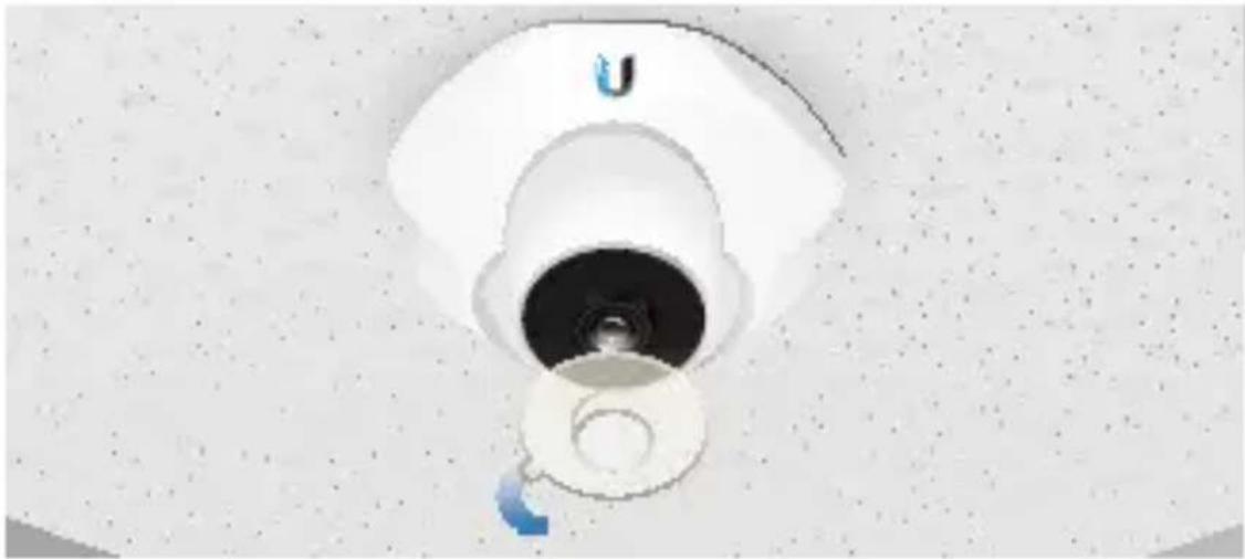 Close-up of a white U-shaped showerhead with a central opening, mounted on a textured surface (no text or symbols visible)