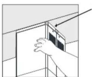 Illustration of a hand placing a wall-mounted device into a cabinet (no text or symbols visible)