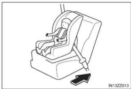Line drawing of a car seatbelt device with a directional arrow indicating motion (no text or symbols)