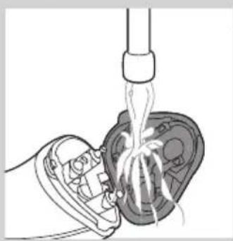 Diagram of a hand inserting a plug into a device with visible internal wiring (no text or symbols)