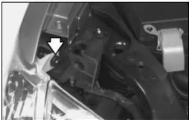 Close-up of mechanical components with a white arrow pointing to a specific part (no visible text or symbols)