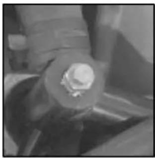 Close-up of a mechanical component with a bolt and nut (no visible text or symbols)