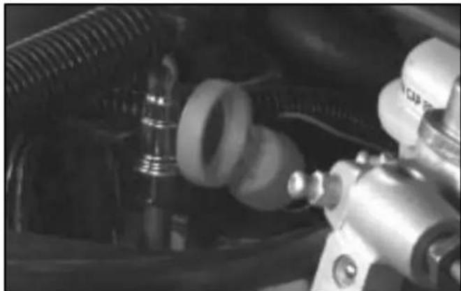 Close-up of mechanical components including hoses and a valve (no visible text or symbols)