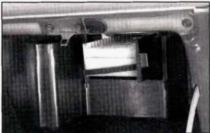 Close-up of a mechanical component with internal parts and mounting holes (no visible text or symbols)