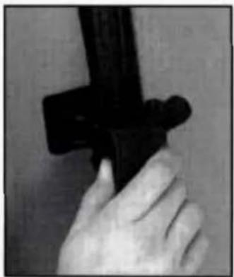 Close-up of a hand holding a black object, possibly a tool or device (no visible text or symbols)
