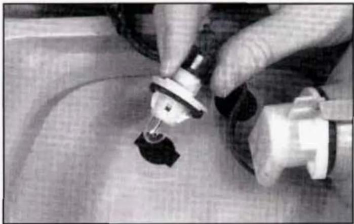 Close-up of hands using a tool to apply material, no visible text or symbols