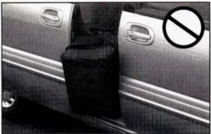 Black-and-white photo of a car with a 'No' sign overlaid, indicating no parking restriction.