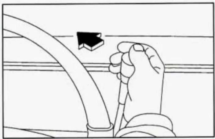 Line drawing of a hand holding a cable with a black arrow pointing to it, against a grid background (no text or symbols)