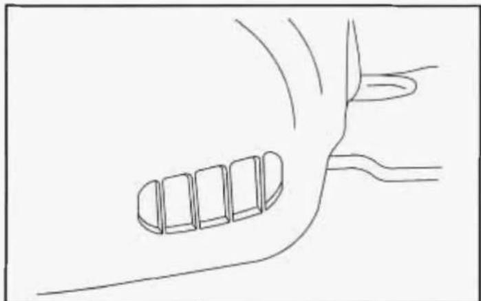 Simple line drawing of a hand holding a small object, possibly a tool or device, with no text or symbols present.