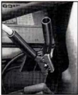 Close-up of a mechanical component with two cylindrical rods and a handle, no visible text or symbols