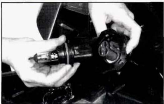 Close-up of hands adjusting a mechanical component with a circular dial (no visible text or symbols)