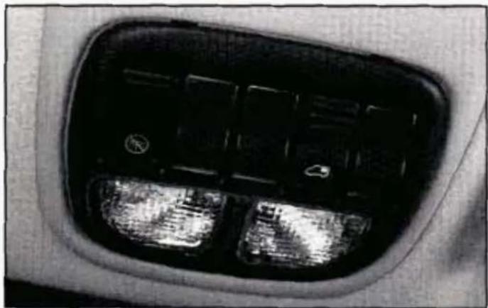 Close-up of a car's front and side panels showing illuminated buttons and dials (no text or symbols visible)