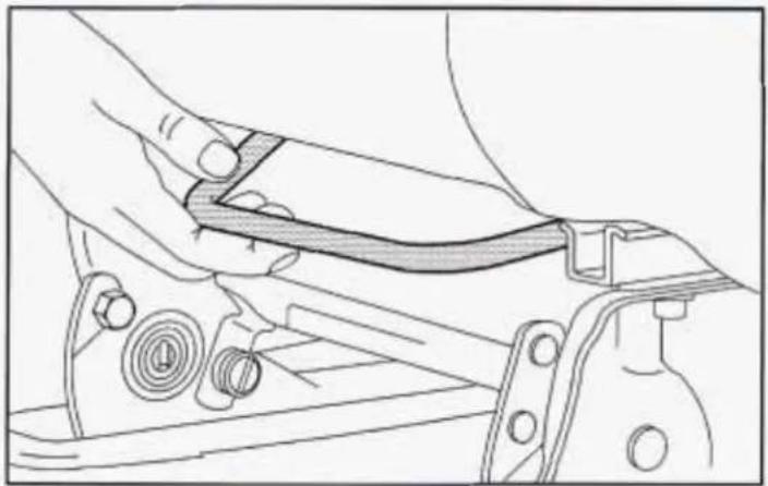Line drawing of a hand adjusting a mechanical component with no visible text or symbols