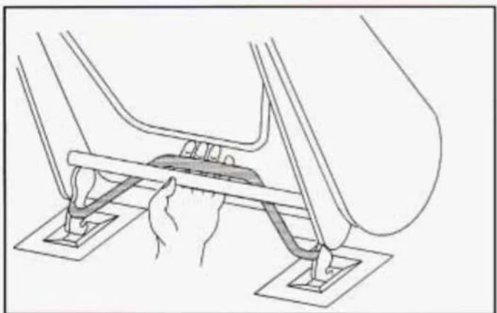 Line drawing of a mechanical assembly with hands holding a central rod (no text or symbols)