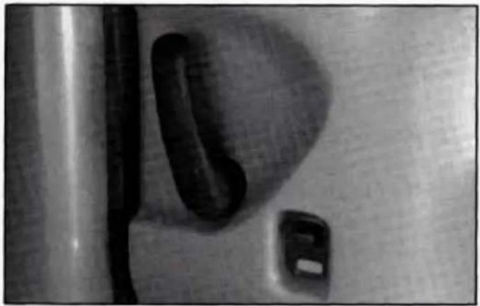 Close-up of a metallic door handle and door with a small inset slot, no visible text or symbols
