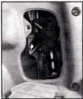 Black-and-white photo of a person inside a vehicle's window, showing the interior scene with no visible text or symbols.